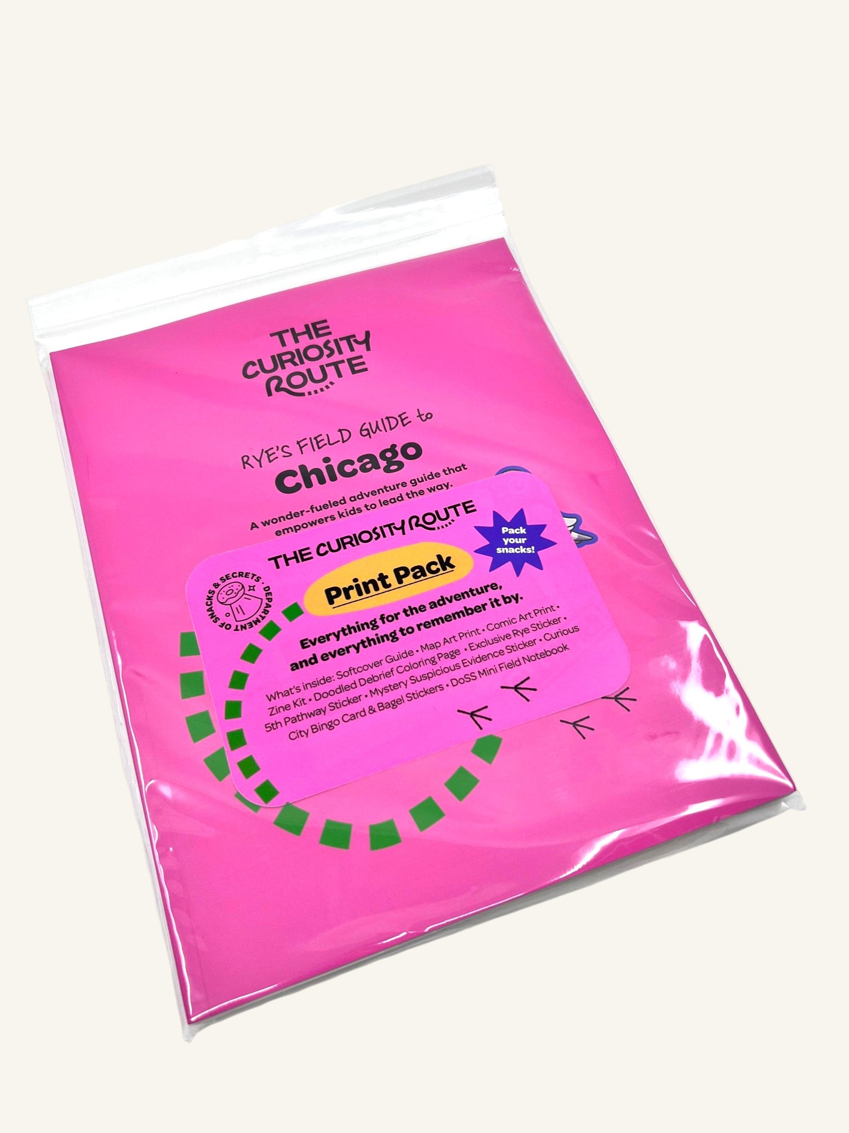 The Curiosity Route Rye's Field Guide to Chicago Print Pack in a bright pink protective sleeve with product details.