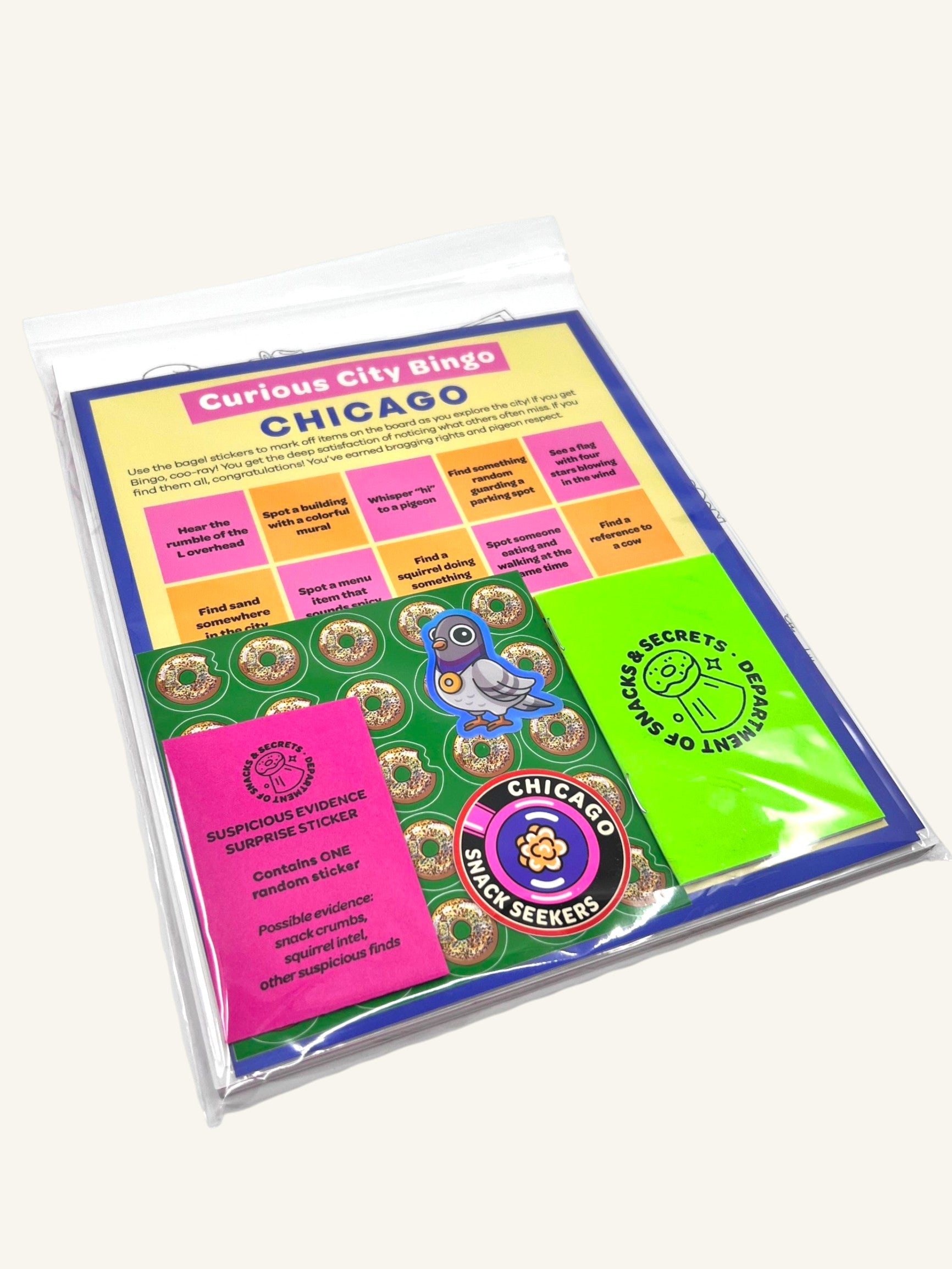 The Curiosity Route Rye's Field Guide to Chicago Print Pack featuring a bingo card, bagel stickers, and badge decals.