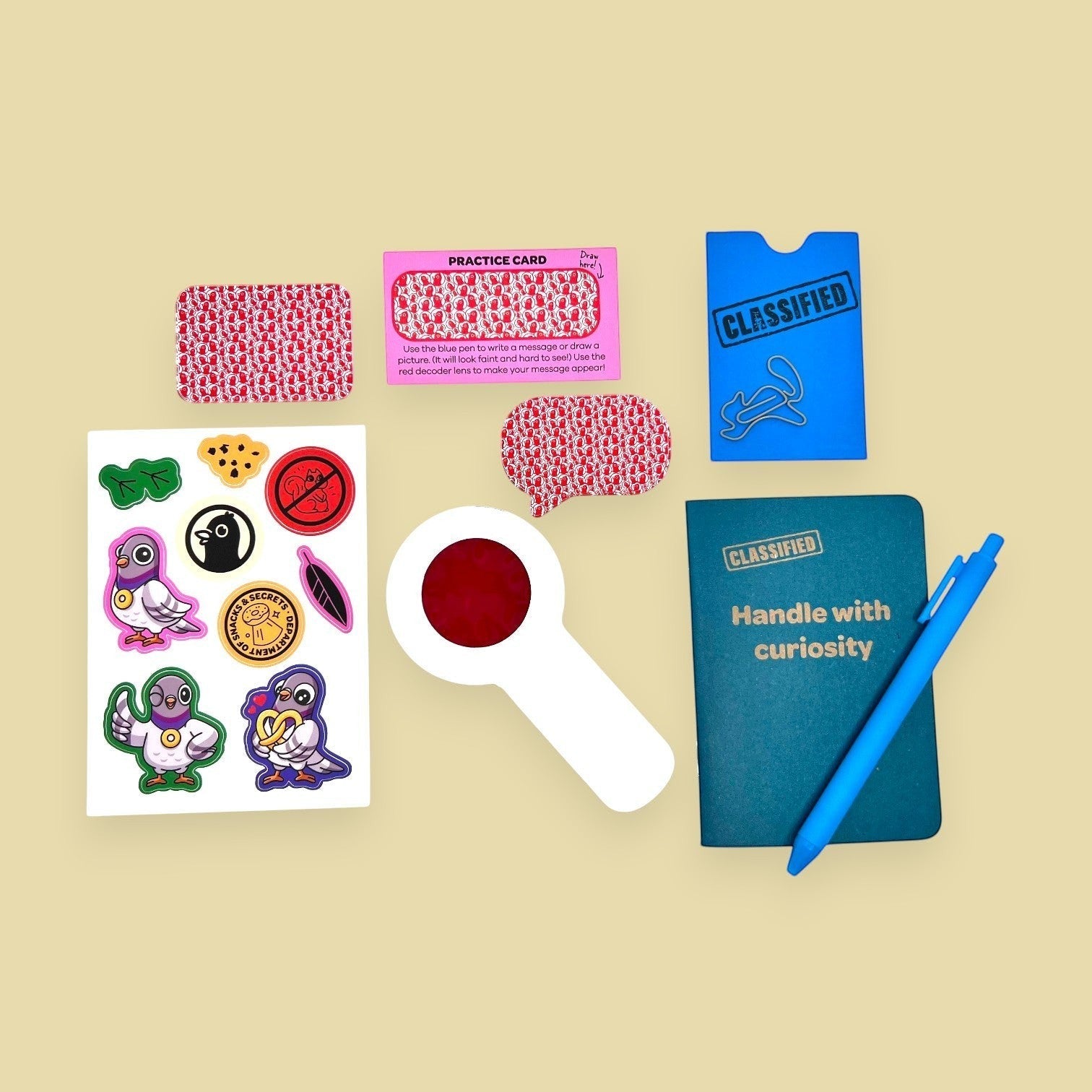 The Curiosity Route Classified Curiosities Kit with a grid-dot notebook, blue pen, decoder lens, and secret stickers.