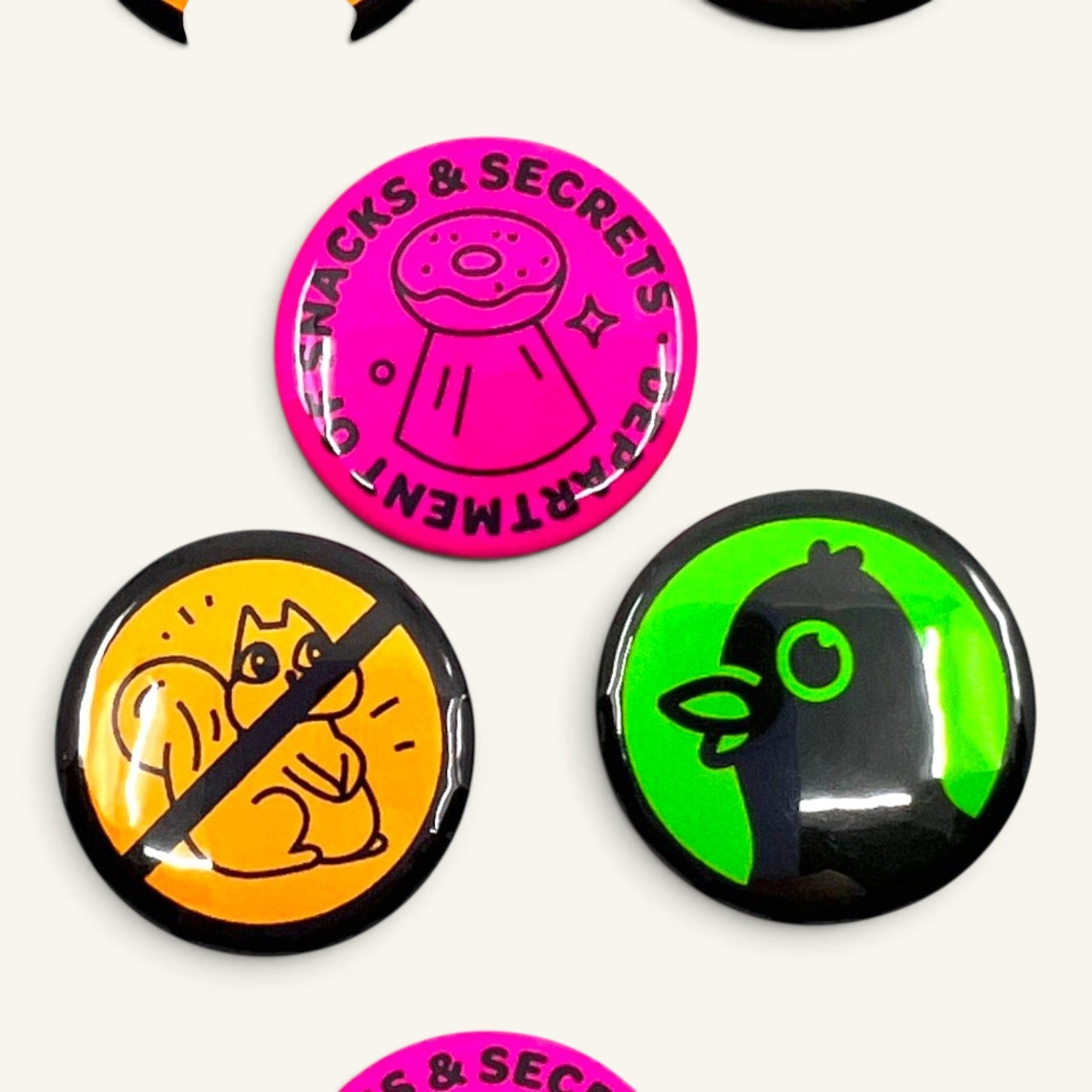 The Curiosity Route DoSS button pack featuring pink, orange, and green 1-inch pinback buttons with graphic designs.