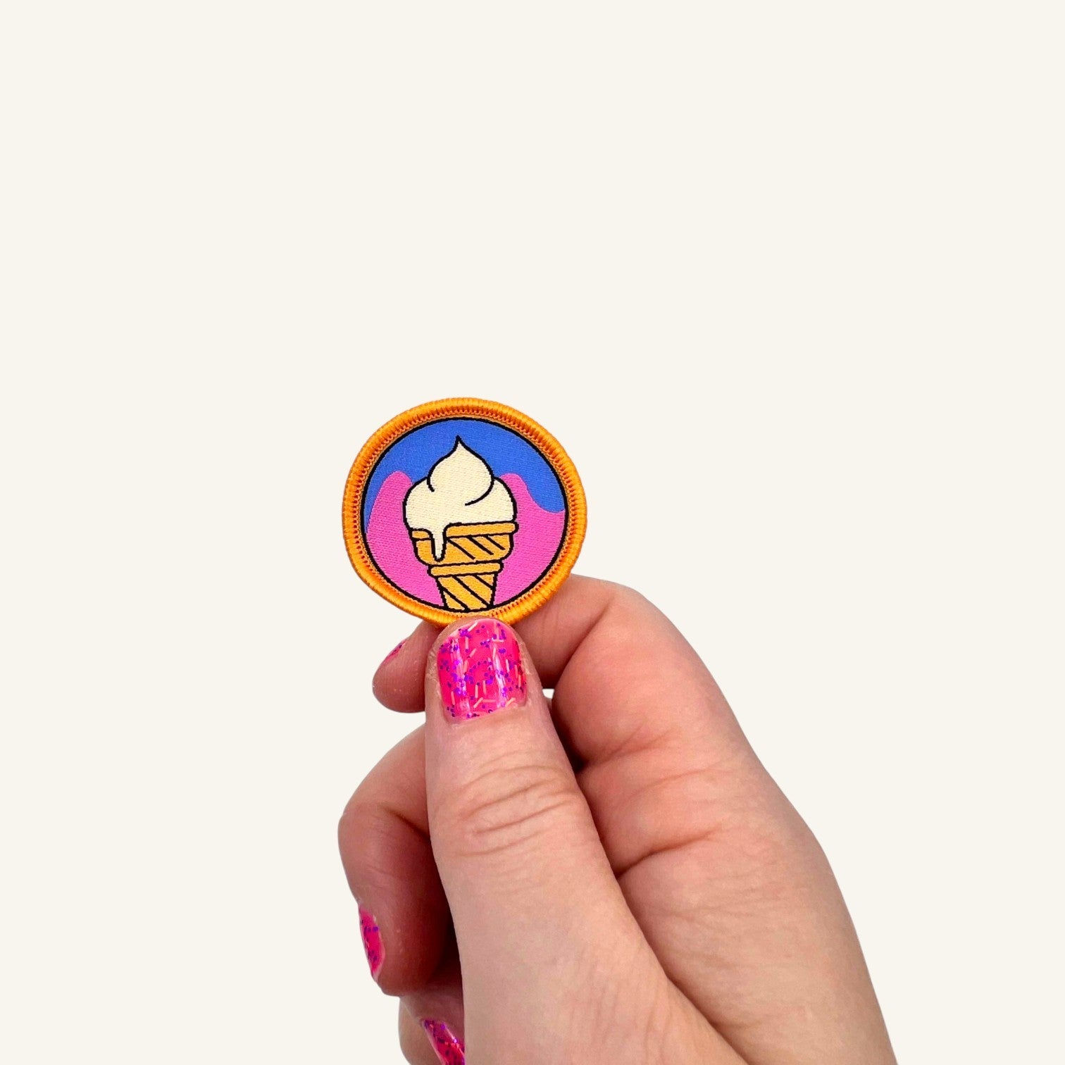 The Curiosity Route Cone Recon iron-on patch featuring a white ice cream cone on a blue and pink background.