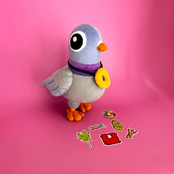 The Curiosity Route plush pigeon toy standing next to a collection of colorful Suspicious Evidence vinyl stickers.