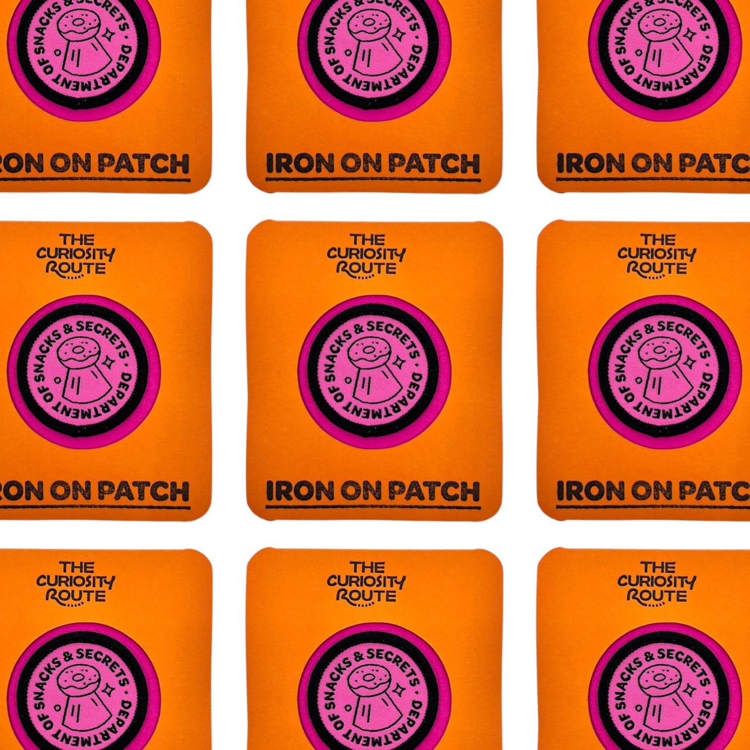 The Curiosity Route circular pink embroidered patch featuring a donut icon and Department of Snacks and Secrets text.