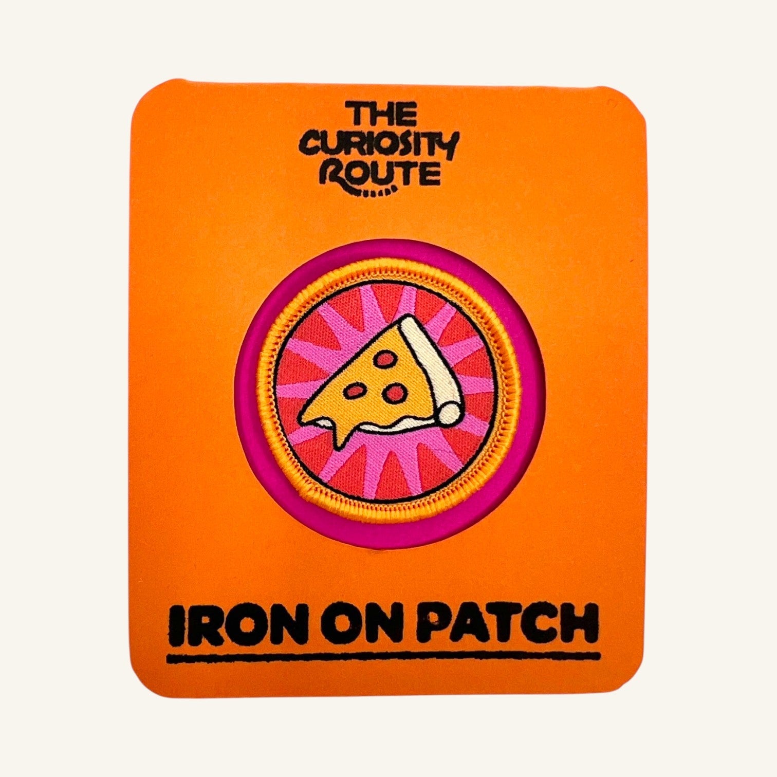 The Curiosity Route Slice Squad woven iron-on patch featuring a pizza slice design on a bright orange backing card.