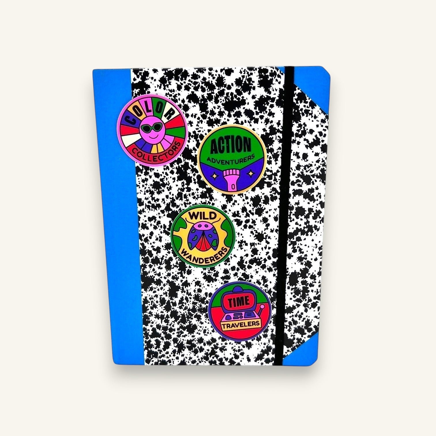 The Curiosity Route matte vinyl stickers featuring colorful designs applied to a blue and black speckled notebook.